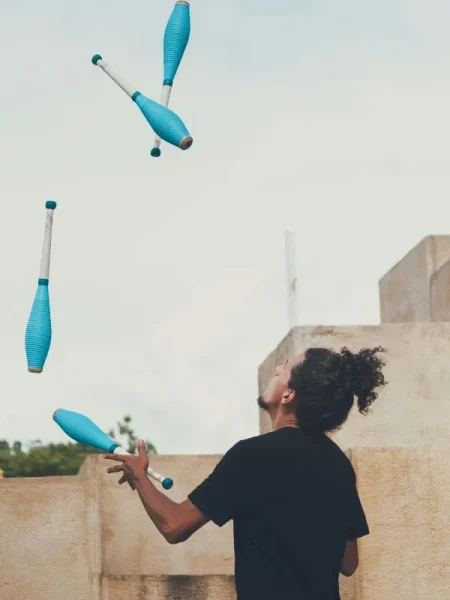 man-juggling-clubs