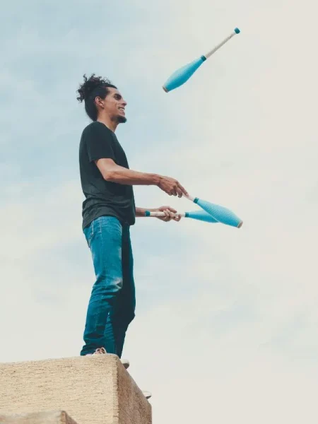 man-juggling-clubs